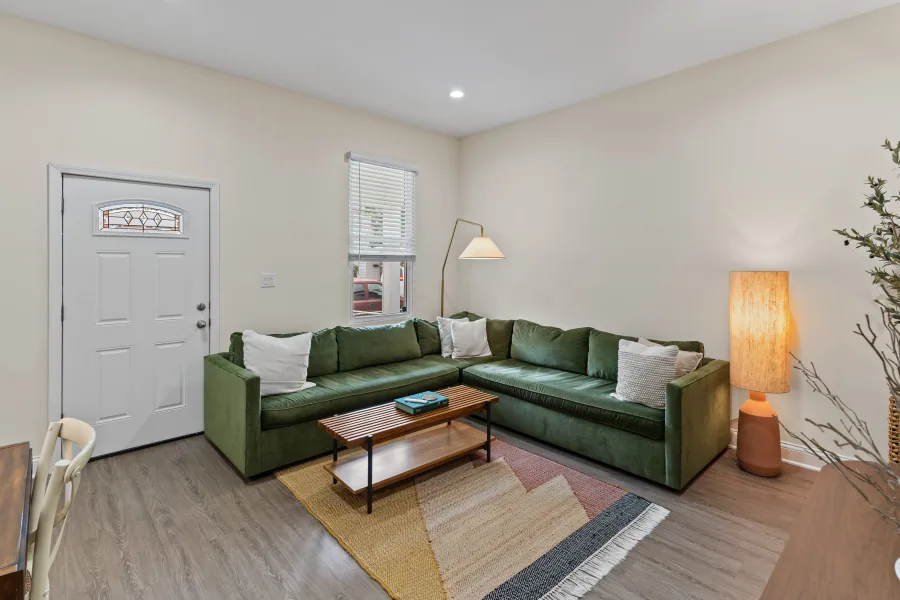 Living room with green sectional sofa, floor lamp, and natural light — photographed by 513Shutter Cincinnati