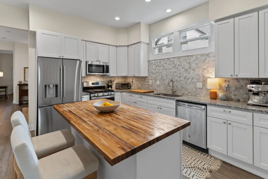 Kitchen with stainless appliances, white cabinetry, and butcher block island — photographed by 513Shutter Cincinnati