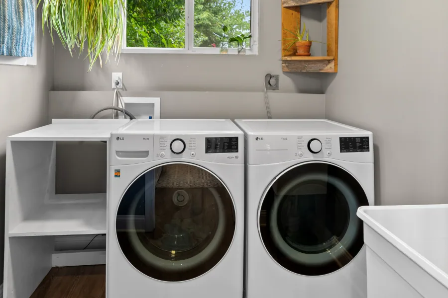 Laundry area with side-by-side washer and dryer and open shelving — photographed by 513Shutter Cincinnati