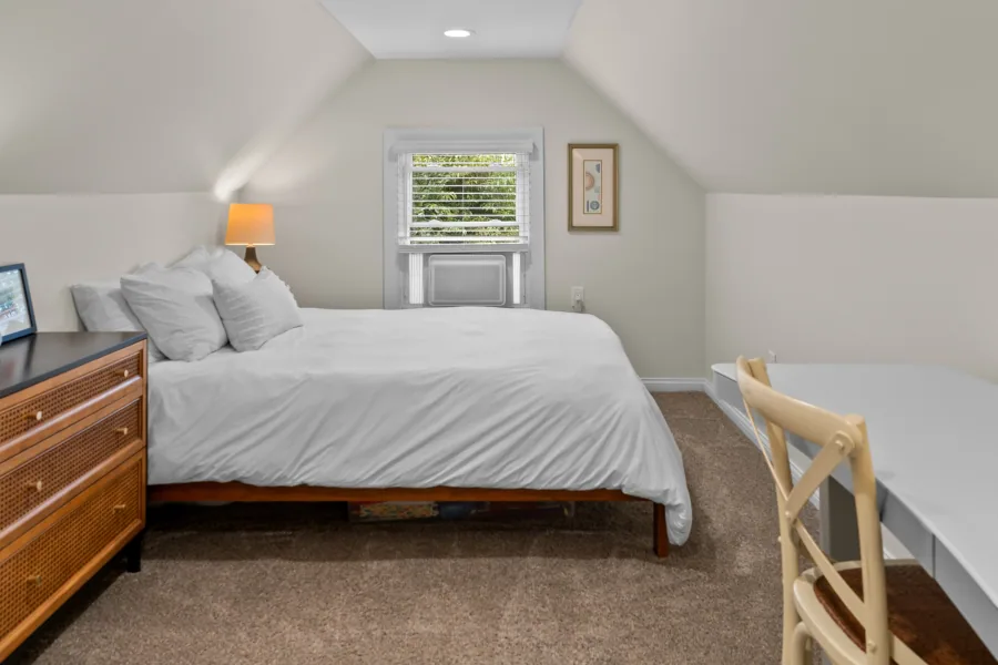 Bedroom with upholstered bed, nightstand, and dormer window — photographed by 513Shutter Cincinnati