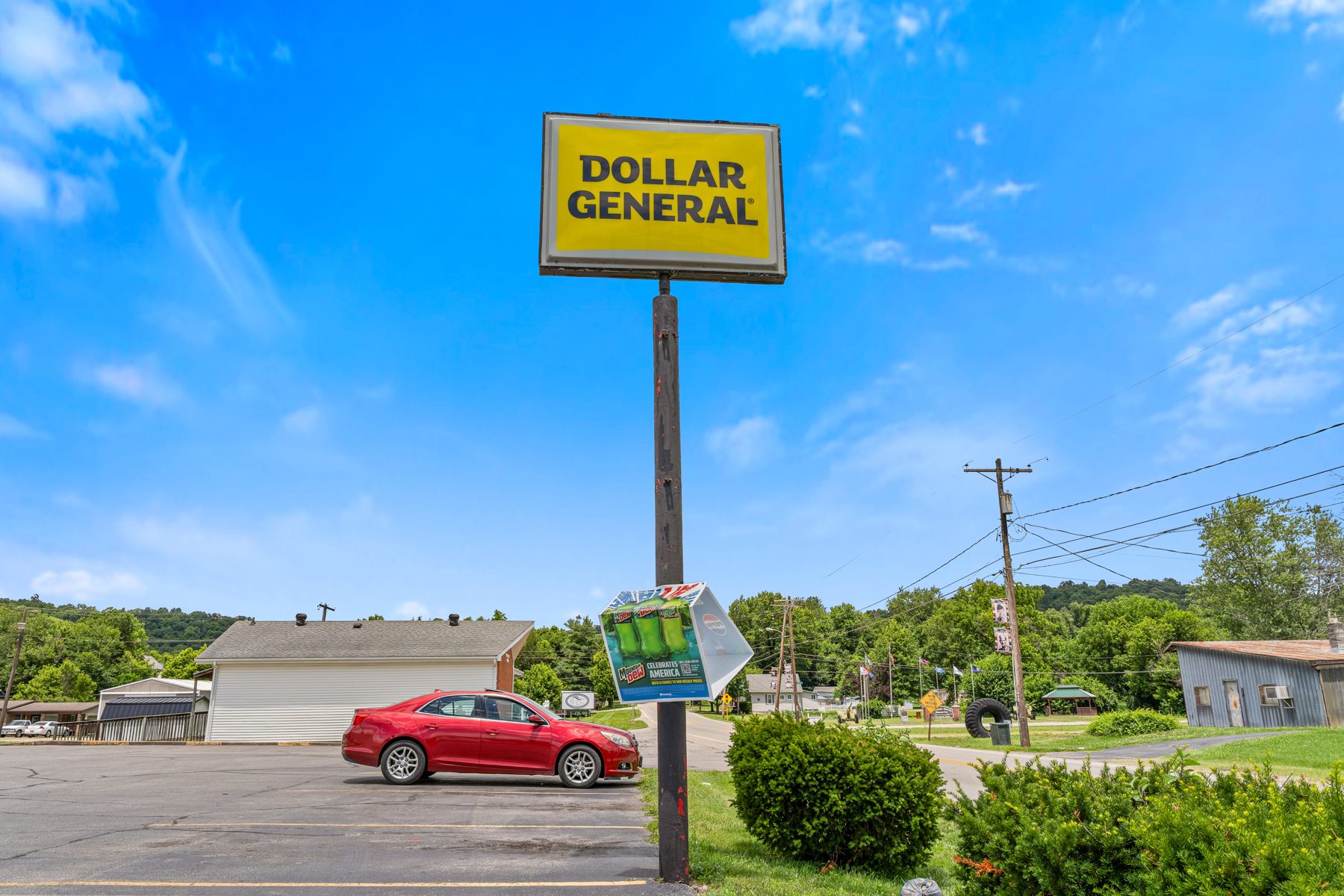 Dollar General pylon sign against a blue sky
