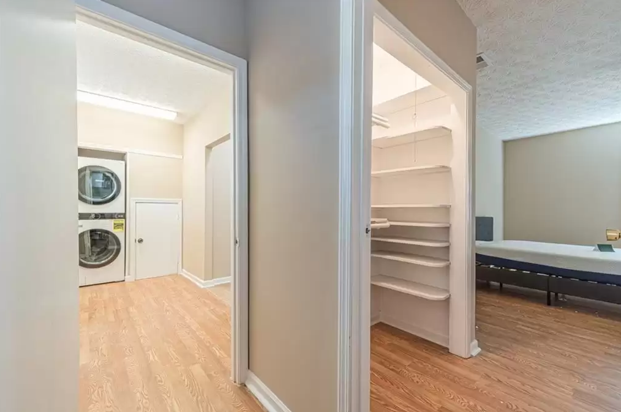 Interior view showing laundry area, closet shelving, and adjacent room